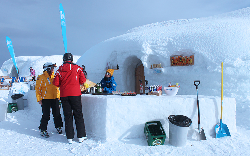 Skiers enjoying drinks at an après-ski igloo bar in Mayrhofen