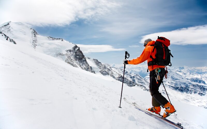 A skier ascending a ski slope in Switzerland