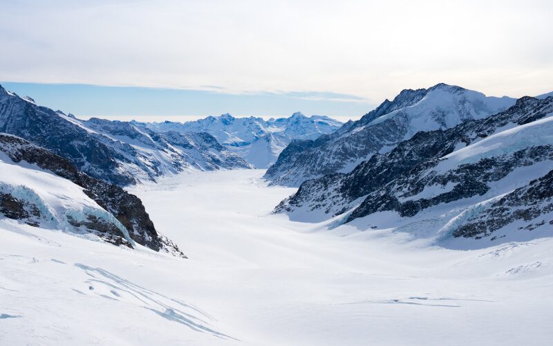 A snowy mountain range with ski slopes in Switzerland