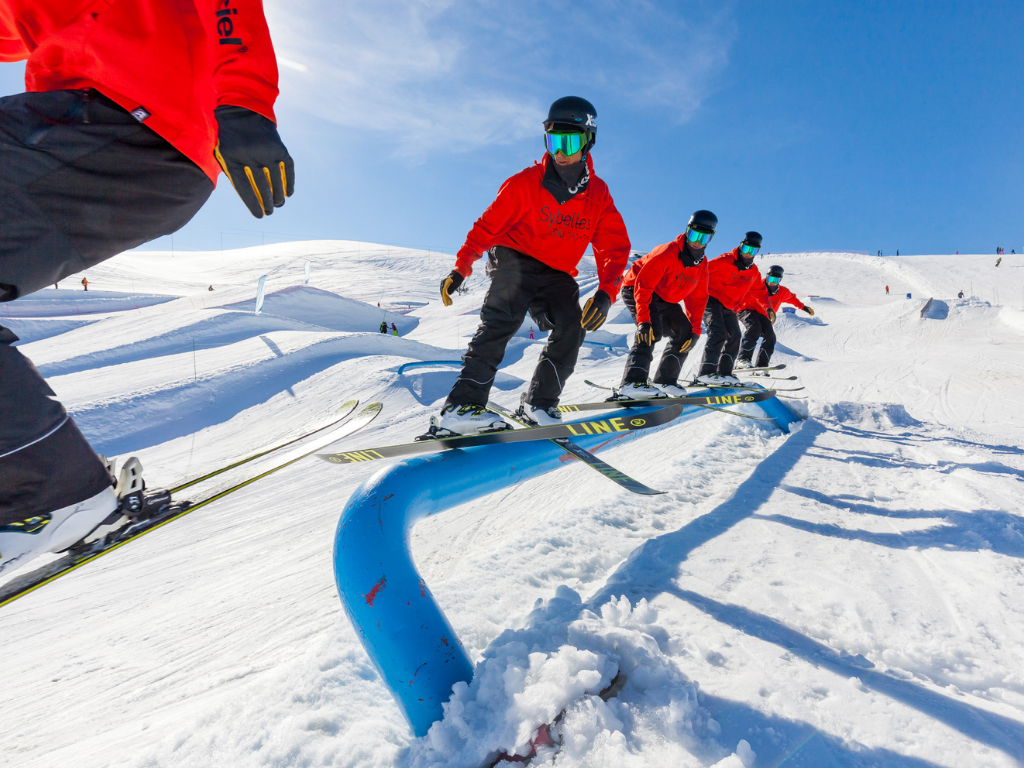 Skier performing a trick in the Les Sybelles snowpark, shown in a multi-exposure sequence that captures each stage of the move.